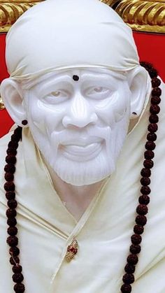 a statue of a man in white with beads around his neck