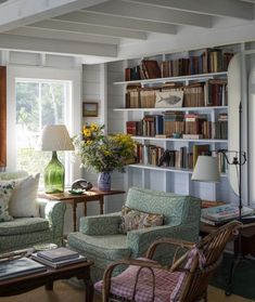 a living room filled with furniture and bookshelves