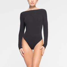 Constructed with our five-star buttery-soft fabric, this bodysuit features a wide scoop neckline and an incredibly sexy open back. Detailed with a thong bottom and snap closures for easy on and off. Fits true to size. | SKIMS Long Sleeve Low Back Bodysuit | Black | XL | Fits Everybody Embellished Bodysuit, High Neck Bodysuit, Scoop Neck Bodysuit, Cami Bodysuit, Square Neck Bodysuit, Mesh Bodysuit, Ribbed Bodysuit, Sleeveless Bodysuit, Lace Bodysuit