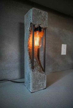 a light that is sitting on top of a cement block in the middle of a room