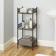 a bathroom shelving unit with towels and soaps