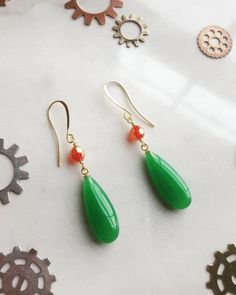 "These beautiful gold earrings with bold green Jade Chalcedony and Red Gold Swarovski crystal are based on the earrings worn by Howl Pendragon. Made with the finest materials, these earrings are a perfect copy of those worn by Howl, and are the perfect addition to any collection or for any Howl Cosplay or costume.  Materials:  Gold-plated earring hooks, Gold wire, Red / Gold Swarovski Crystal, High quality green jade Chalcedony drops.  The full length of the earrings is 2.25\" inches hanging, th Green Briolette Earrings For Pierced Ears, Green Briolette Earrings For Gifts, Howl Cosplay, Beautiful Gold Earrings, Howls Moving Castle Earrings, Howl Pendragon, Chalcedony Earrings, Howls Moving Castle, Red Bead