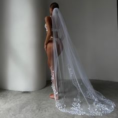 a woman in a white wedding dress and veil