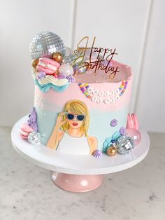 a birthday cake decorated with an image of a woman wearing sunglasses and holding a disco ball