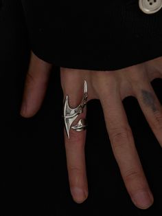 a person's hand with a ring on it