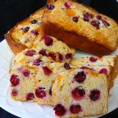 slices of bread with cranberry toppings on a white plate