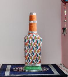 a decorative bottle sitting on top of a rug