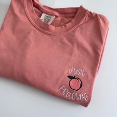 My absolute favorite tee! This 'just peachy ' tee is embroidered on a Comfort Colors short sleeve unisex tee.  Please wash on gentle cycle and dry on low.  If you are wanting a different design, wording, or a different clothing style, please send me a message so we can discuss the details. Please include thread color at checkout If you need this order rushed, please add these to your cart: https://www.etsy.com/listing/1043569716/rush-my-order-for-t-shirts?ref=shop_home_active_19&frs=1 Rush my or Cute Peach T-shirt With Crew Neck, Heather Peach Relaxed Fit Crew Neck T-shirt, Pink Crew Neck T-shirt With Embroidered Graphics, Spring Peach Crew Neck T-shirt, Cute Pink T-shirt With Letter Embroidery, Pink Cotton T-shirt With Embroidered Graphics, Heather Peach Cotton Short Sleeve T-shirt, Heather Peach Short Sleeve Cotton T-shirt, Pink Embroidered Cotton T-shirt