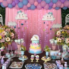 a table filled with lots of desserts and balloons