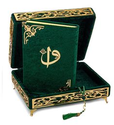 an open green box with gold trimmings and a tassel hanging from it