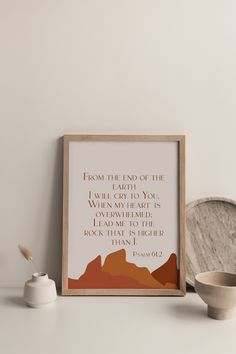 a framed poster with the words from the end of the earth on it next to a bowl