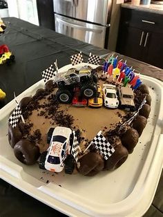 a birthday cake with cars and candles on it