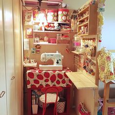 a sewing machine sitting on top of a table in a room filled with crafting supplies