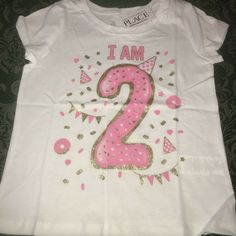 NWT I am 2 years old birthday shirt sz 3t 3 brand new with tags from tcp the childrens place size 3t 3 shirt top short sleeves for the birthday girl who is turning 2 years old great present for her to wear to her birthday party or wear all year long to remember just exactly how old she is has the number 2 large on it with a party hat and lots of confetti reads I AM and then the year old number glitter gold design along with the pink 2nd birthday I have mutiples available for sisters twins triple Pink Glitter Print Top For Birthday, Gold Letter Print T-shirt For Party, Gold Top With Graphic Print For Birthday, Gold Graphic Print Top For Birthday, Gold Tops With Letter Print For Gifts, Gold Short Sleeve Top As Gift, Gold Top With Graphic Print, Gold Short Sleeve Tops With Glitter Print, Gold Short Sleeve Top With Glitter Print