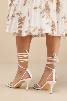 Make an entrance unlike any other with a fabulous look like the Lulus Lawrance White Lace-Up High Heel Sandals! Smooth faux leather shapes these trendy lil' heels that feature a classic square-toe footbed, a network of slender straps that create a peep-toe upper, and matching straps that weave through a supportive heel strap to wrap and tie above the ankle. 3. 25" wrapped stiletto heel. Cushioned insole. Rubber sole has nonskid markings. Man made materials. Imported. Lulus | Lawrance White Lace-Up High Heel Sandal Heels | Size 10. Chic Block Heel Sandals For Events, Open Heel Sculpted Heels For Events, Elegant Summer Wedding Shoes With Heel Loop, Chic Summer Wedding Shoes For Gala, Elegant Summer Wedding Shoes With Heel Strap, Elegant Wedding Shoes With Heel Strap For Summer, Event Sandals With Padded Heel And Fitted Style, Event Sandals With Padded Heel And Fitted Design, Event Sandals With Padded Heel