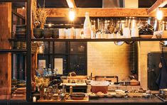 a kitchen filled with lots of clutter and cooking utensils