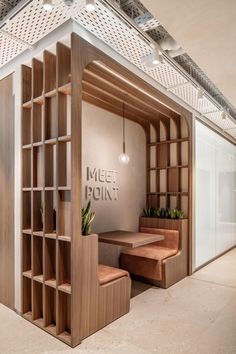 the inside of an office building with wooden shelves and planters on each side of the wall