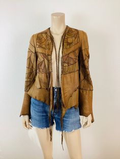 Vintage Patchwork Leather Jacket patchwork leather bell sleeves with raw edge braided leather ties at front supple brown leather artisan made, signed but not readable great vintage condition appx size - S 19 pit-pit 19 length  26.5 sleeve 14 shoulder All sales are final Leather Jacket For Fall Festival, Designer Brown Leather Jacket For Spring, Hippie Brown Outerwear For Festivals, Vintage Leather Jacket For Fall Festival, Long Sleeve Patchwork Leather Jacket For Spring, Fall Leather Jacket With Patchwork, Patchwork Leather Jacket For Fall, Vintage Long Sleeve Leather Jacket For Festival, Bohemian Hand-stitched Outerwear For Fall