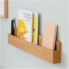 a book shelf with books and pens on it