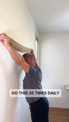 a man is painting the wall with white paint