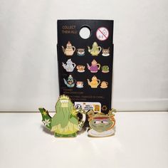 some disney figurines are sitting in front of a card holder and magnets