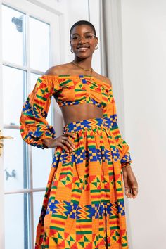 Matching two piece set  Unlined Side Pockets  One Split at the Front  Elastic at the Back  Length of the Skirt 45 inches Long  100% African print design. Polyester blend..This dress is made from a light weight fabric great for summer and events.  First Model is 5'7 and wears a US4/UK8. Made in Gambia 🇬🇲  Care Instructions: Hand wash cold. Press with cool iron on the wrong side only. Do not bleach. Hang dry. Fitted Orange Set For Vacation, Multicolor Long Skirt Sets For Spring, Fitted Multicolor Tops Matching Set, Fitted Multicolor Sets With Vibrant Print, African Print Two Piece, Orange African Print Dress, Fitted Orange Bohemian Sets, Fitted Multicolor Two-piece Tops, Fitted Cropped Multicolor Sets