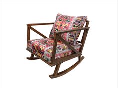 a wooden rocking chair with colorful fabric on it's back and armrests