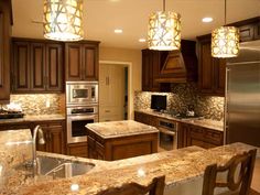 a large kitchen with granite counter tops and wooden cabinets, along with stainless steel appliances