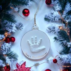 a christmas ornament with a handprint on it