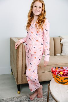 We have the perfect pjs for you this spooky season! They are so cute with all those little ghostys, bats, and pumpkins! This pjs set is sure to be a fan favorite especially since we also carry this set in adult sizes so you and your mama can match this Halloween season! Top: Collared neckline Button down front closure Long sleeves White piping Halloween print Generous stretch Bottoms: Elastic waist Halloween print Generous stretch Glory is wearing the medium. Cute Pajama Party Sets For Fall, Fun Long Sleeve Sleepwear For Pajama Party, Playful Loungewear Sets For Fall, Cute Sleepwear For Pajama Party In Fall, Cute Sleepwear For Sleepover, Casual Fall Sets For Sleepovers, Playful Sets For Pajama Party In Fall, Cute Fall Sleepwear For Pajama Party, Cute Long Sleeve Sets For Halloween