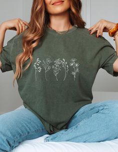 Floral Cottagecore Shirt | Cute Wildflower Shirt | Autumn Shirt | Fall Vibes This shirt is perfect everyday wear! The adorable fall  tee creates a trendy and stylish look. Features: Available in various sizes and colors, making it a fantastic gift for family and friends. Ideal for fall, Floral Cottagecore, and casual outings. Great for Wildflower lovers and autumn enthusiasts. Details: Check the color charts for available options. Made from soft material with a modern classic fit, ensuring comfo Green Crew Neck Top With Floral Print, Green Floral Print Crew Neck Top, Casual Green Tops With Plant Print, Green Short Sleeve Tops With Plant Print, Green Short Sleeve Shirt With Plant Print, Green Tops With Plant Print Short Sleeves, Relaxed Fit Crew Neck Tops With Plant Print, Green Letter Print Top For Spring, Spring Green Top With Letter Print