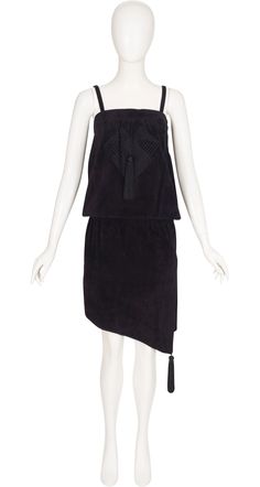 This 1980s Claude Montana for Ideal Cuir sleeveless blouson dress was made in France of black suede lined in rayon. It has an embroidered design on the front with a tassel, another tassel on the left side of the asymmetrical hemline, and an elastic waistband. It zips up the left side, and is in very good condition. Measurements: Top Band - 30.5" Bust - approx. 34" Waist - 28"-36" Hips - 36" Label Size: 38 IMPORTANT NOTE FOR CANADIAN SHOPPERS: There is a 15% shipping fee that is automatically applied to Canadian orders, as legally we need to charge and remit sales tax domestically. We will promptly refund any overcharge, and apologize for any inconvenience. Claude Montana, Top Band, Suede Tassel, Blouson Dress, 1980s Vintage, Embroidered Design, Dress Clothes For Women, Black Suede, Made In France