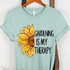 Hi, Welcome to Our Store! Embrace the tranquility of nature with our 'Gardening is my Therapy' shirt! Perfect for garden lovers and Plant Lover, this soft and comfortable tee is adorned with a charming garden-themed design. Whether you're tending to your blooms or simply enjoying the beauty of the Gardener, let this shirt remind you that life truly flourishes in the garden. Available in a variety of sizes and colors, it makes a delightful addition to any wardrobe or a thoughtful gardening gift f Relaxed Fit Graphic Print Shirt For Gardening, Relaxed Fit Shirt With Graphic Print For Gardening, Relaxed Fit T-shirt For Gardening In Spring, Short Sleeve Shirt For Gardening In Spring, Spring Gardening Short Sleeve Tops, Cotton Shirt For Gardening In Summer, Summer Cotton Shirt For Gardening, Green Plant Print Tops For Gardening, Green Tops With Plant Print For Gardening