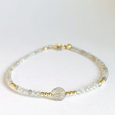 Tiny Moonstone Sparkle Bracelet Janine Gerade Gold Moonstone Beaded Bracelet As A Gift, Spiritual Gold Beaded Bracelets With Moonstone, Spiritual Gold Bracelets With Moonstone, Gold Beaded Bracelets With Gemstone Moonstone Beads, Gold Bracelets With Tiny Beads For Healing, Handmade Gold Moonstone Beaded Bracelets, Gold Moonstone Round Bracelets, Gold Moonstone Round Beads Jewelry, Gold Moonstone Jewelry With Round Beads