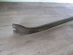 an old rusty wrench sitting on top of a wooden table