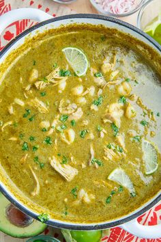 a large pot filled with green food and garnished with cilantros