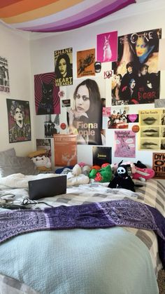 a bed with lots of posters on the wall