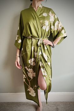 Beautiful Japanese style Kimono,  with bright colourful floral print. These gowns feel beautiful and drape very well on the body, luxurious fabric with painted pink orchids trailing through the print, They are very feminine.  With 3/4 sleeves and tie belt. machine washable on cool cycle. Free Size fits UK 8 - 16 Great to wear around the house, or can be dressed up with T-Shirt & Jeans to wear out. A luxurious birthday or Gift Idea. We can gift wrap pop in the post with a personalised message for a friend or a loved one. We have a full range of designs to suit everyone Elegant Green Maxi Kimono, Elegant Green Maxi-length Kimono, Spring Wedding Green Kimono, Elegant Green Dress With Kimono Sleeves, Spring Wedding Dress With Kimono Sleeves, Elegant Green Spring Robe, Long Spring Wedding Night Dress, Spring Wedding Night Long Dress, Fitted Dresses With Kimono Sleeves For Daywear