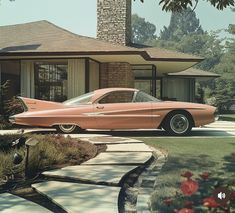 an old pink car parked in front of a house