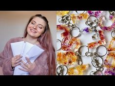 a woman standing next to a bunch of key chains