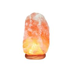 an orange himalayan salt lamp on a wooden stand