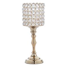 a gold candle holder with crystal balls on it's sides and a metal base