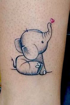 an elephant with a heart tattoo on its leg