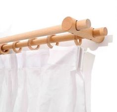 the curtain rod is made out of wood and has two hooks on each one side