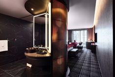 a bathroom with black walls and marble flooring