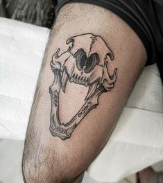 a man with a skull tattoo on his leg