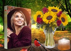 a beautiful woman sitting next to a vase filled with sunflowers and red roses