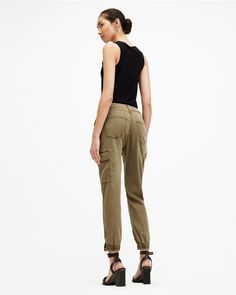 Swap your sweatpants out. Try the Nola Joggers. They're crafted from a stretch cotton-blend fabric that's super comfortable. Finished with classic cargo pocket detailing - pair them with a bodysuit for an easy look that goes from day to night.    These trousers are designed to a slim fit High-rise Zip closure Ankle length Cuffed ankles Stretch fabric Four cargo pockets Zip side seam at the ankle Allsaints Relaxed Fit Cotton Bottoms, Relaxed Fit Straight Leg Cargo Joggers, Relaxed Fit Cargo Joggers With Straight Leg, Casual Spring Allsaints Bottoms, Utility Cargo Style Sweatpants With Tapered Leg, Spring Cargo Style Tapered Leg Sweatpants, Allsaints Cotton Bottoms For Spring, Stretch Cotton Cargo Sweatpants, Fitted Allsaints Bottoms For Spring