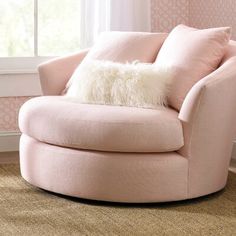 a pink chair with a fluffy pillow on it