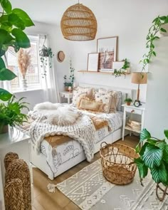 a bed room with a neatly made bed and lots of plants